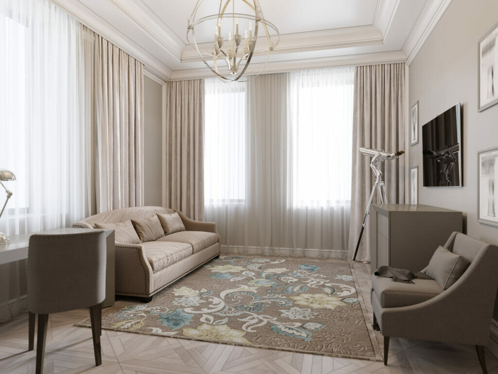 A living room with beige walls and a beige rug.
